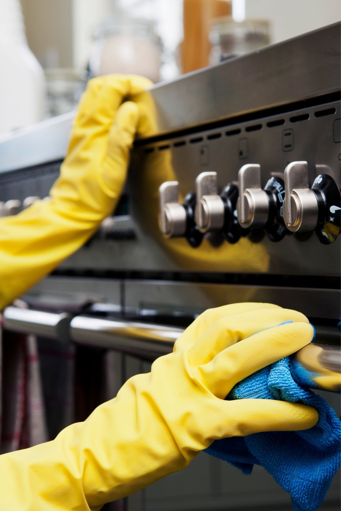 Main gantée nettoyant une surface d’électroménager dans un cadre domestique soigné  à Asbestos